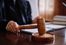 Judge holding gavel in courtroom