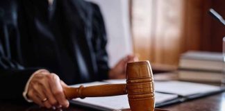 Judge holding gavel in courtroom