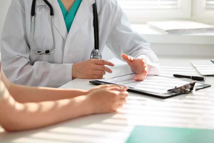 50075309 featured image Doctor discussing with patient holding clipboard on desk