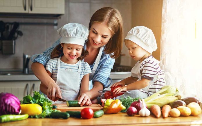 680767063 featured image Family cooking together with vegetables in kitchen