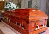 Wooden casket with white flowers in a funeral home