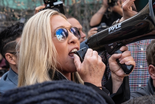 shutterstock_2284802513 (5).jpg featured image Woman shouting into megaphone while in a crowd.