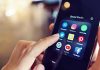 Finger tapping smartphone social media app icons