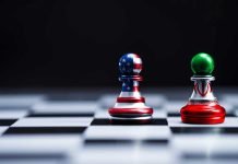 Chess pieces with USA and Iran flags on board