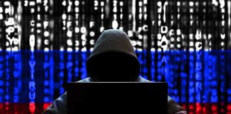 Hacker in hoodie with Russian flag background and code