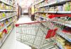 Empty shopping cart in grocery store aisle