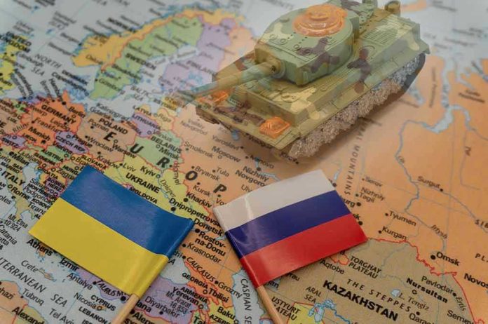 2114384846 Toy tank on map with Ukraine and Russia flags