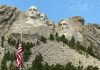Mount Rushmore with American flag in the foreground