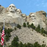 Mount Rushmore with American flag in the foreground