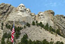 Mount Rushmore with American flag in the foreground