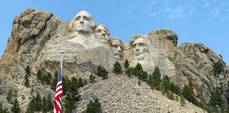 Mount Rushmore with American flag in the foreground