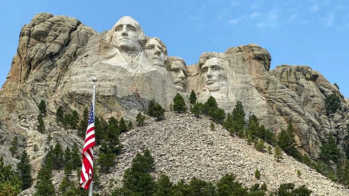 2299753463 Mount Rushmore with American flag in the foreground