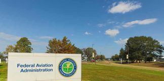 Federal Aviation Administration sign on grassy lawn.