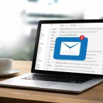 Laptop with email notification on screen at desk