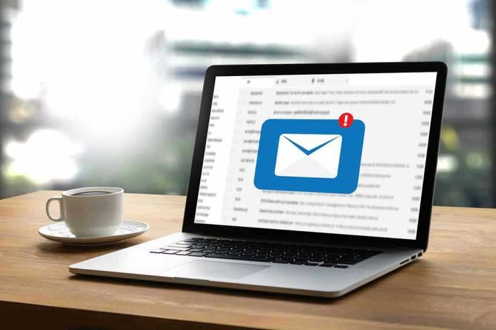 Laptop with email notification on screen at desk