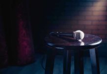 Microphone resting on a stool on stage