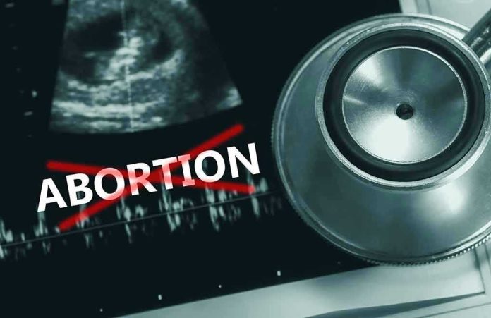 2171348999 Ultrasound, stethoscope, and "ABORTION" crossed out in red.