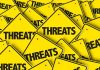 Yellow warning signs with the word "THREATS".