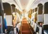Passengers seated inside an airplane cabin.