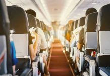 Passengers seated inside an airplane cabin.