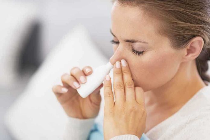 shutterstock_149120279.jpg Woman applying nasal spray for relief