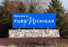 Welcome sign for Pure Michigan with a blue background and stone base