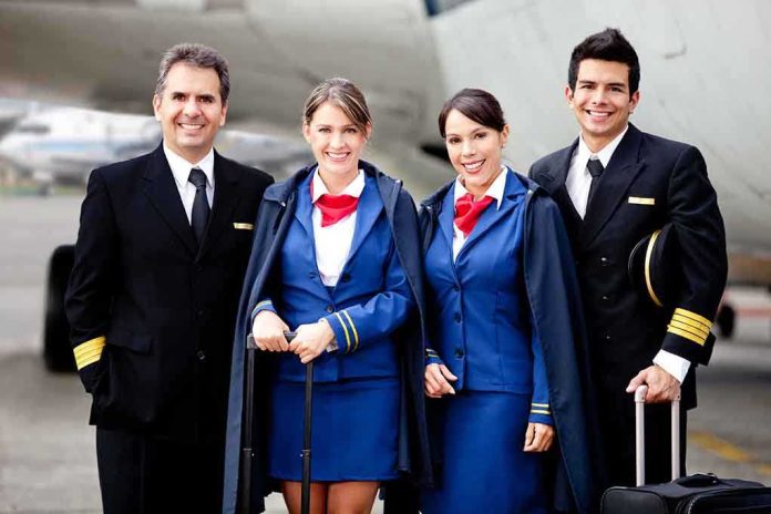 shutterstock_96912926.jpg Group of airline crew members posing together at an airport