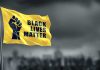 Yellow Black Lives Matter flag with clenched fist.