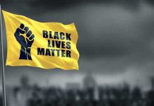 Yellow Black Lives Matter flag with clenched fist.