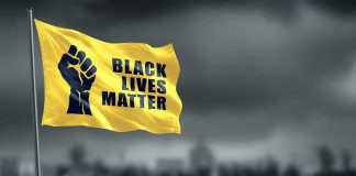 Yellow Black Lives Matter flag with clenched fist.