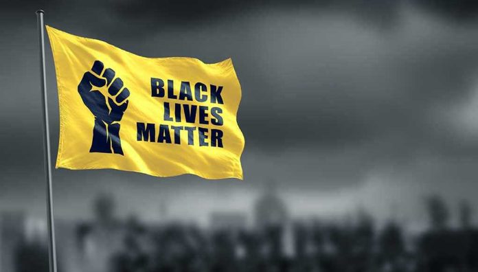 1756895792 Yellow Black Lives Matter flag with clenched fist.
