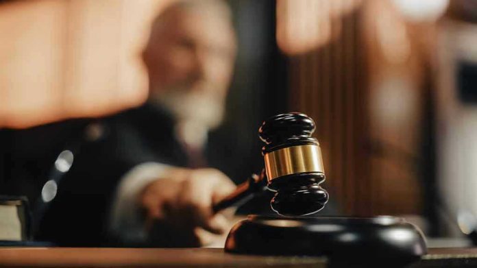 2056414424 Judge using gavel in a courtroom setting.