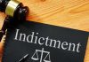 Gavel next to indictment document on table