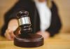 Judge striking gavel in a courtroom.