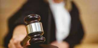 Judge striking gavel in a courtroom.