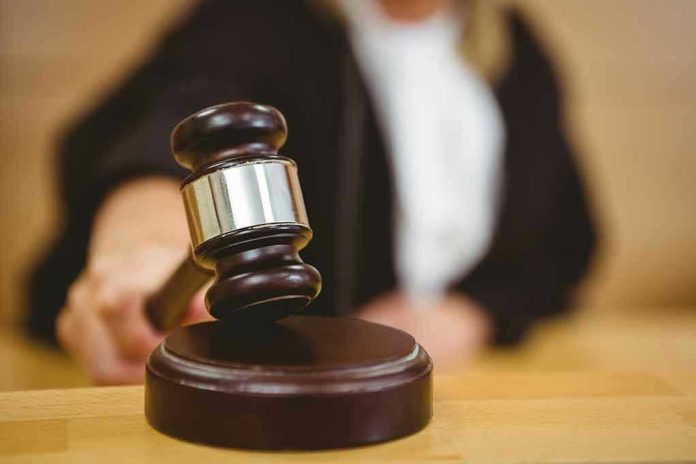 Judge striking gavel in a courtroom.