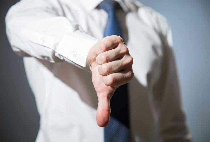 314376254 Person giving a thumbs down gesture.