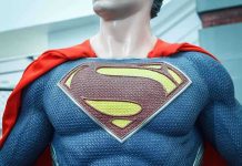 Close-up of a Superman statue wearing a blue costume and red cape