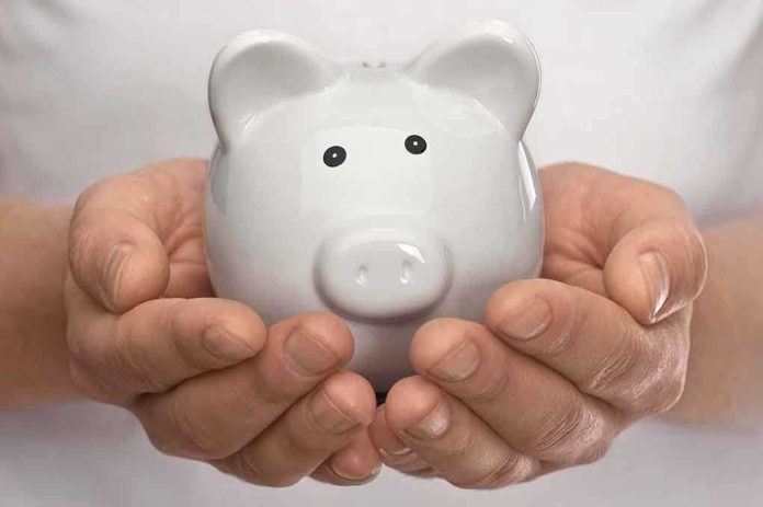 Hands holding a white ceramic piggy bank