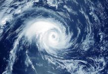 Hurricane DEVASTATION: 25,000 Tourists Trapped! Satellite image of a swirling hurricane over ocean.