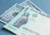 $100 bill and U.S. Treasury check.