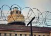 UNPRECEDENTED Gunfire – Federal Prison LOCKDOWN! Barbed wire in front of a prison tower.