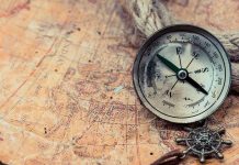 VANISHED Picasso Masterpiece FOUND—Located Where? Old compass on a vintage map background.