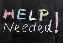 Help Needed written in colorful chalk.