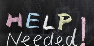 Help Needed written in colorful chalk.