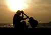 Unthinkable Loss—Rock Icon Passes Away Silhouette of a guitarist sitting by the ocean during sunset