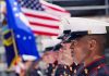 Trump FEDERALIZES State Guard — Court VICTORY! Marines in uniform standing in formation with flags in the background