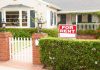 A house with a For Rent sign in the front yard