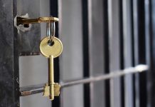 Maxwell’s Prison PRIVILEGES Spark Nationwide Fury Key in lock of prison cell door.