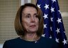 Pelosi’s Wealth SURGES – 16,930% Return? Person standing near American flag indoors